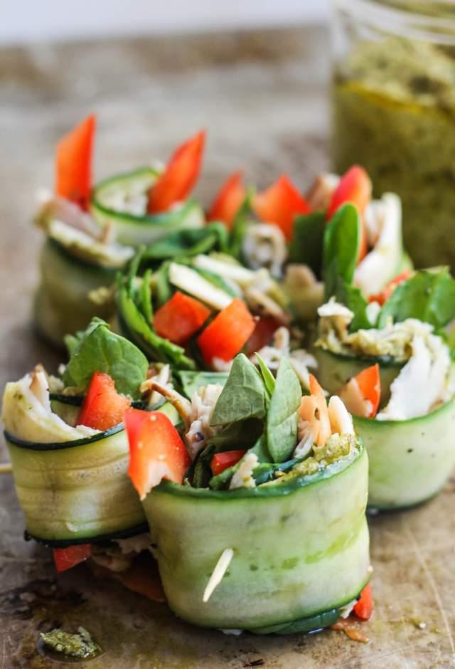 Spread about 1 teaspoon of pesto on each cucumber, then evenly distribute cheese, turkey, bell pepper and spinach on each. Sprinkle with a little salt and black pepper.