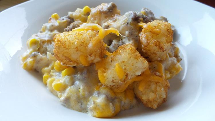 Cowboy Casserole 1 pound lean ground beef 1 bag of tater tots (30oz) - defrosted 1 medium onion (chopped) 1 can cream of broccoli 1 can corn (drained) 2 cups shredded cheese 1/2 cup milk 4