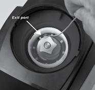 Cleaning the Grinding Chamber Exit Port: Turn the grinder so the back is facing you, then rotate the black adjustment ring counter clockwise until it stops.
