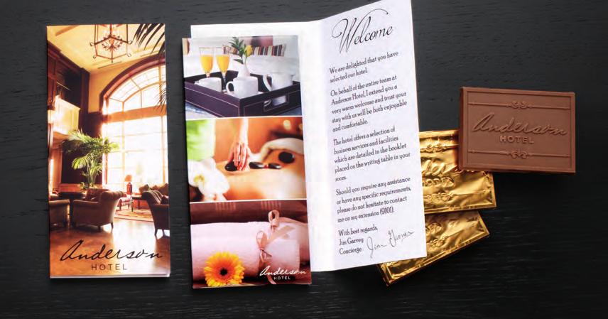 The custom printed card opens to feature the full-colour printed Deluxe Trio box inside, which holds three custom chocolate pieces. Each piece is individually wrapped in gold foil.