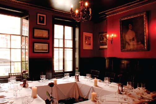The room is wood panelled, hung with oil paintings, ornate mirrors and chandeliers.