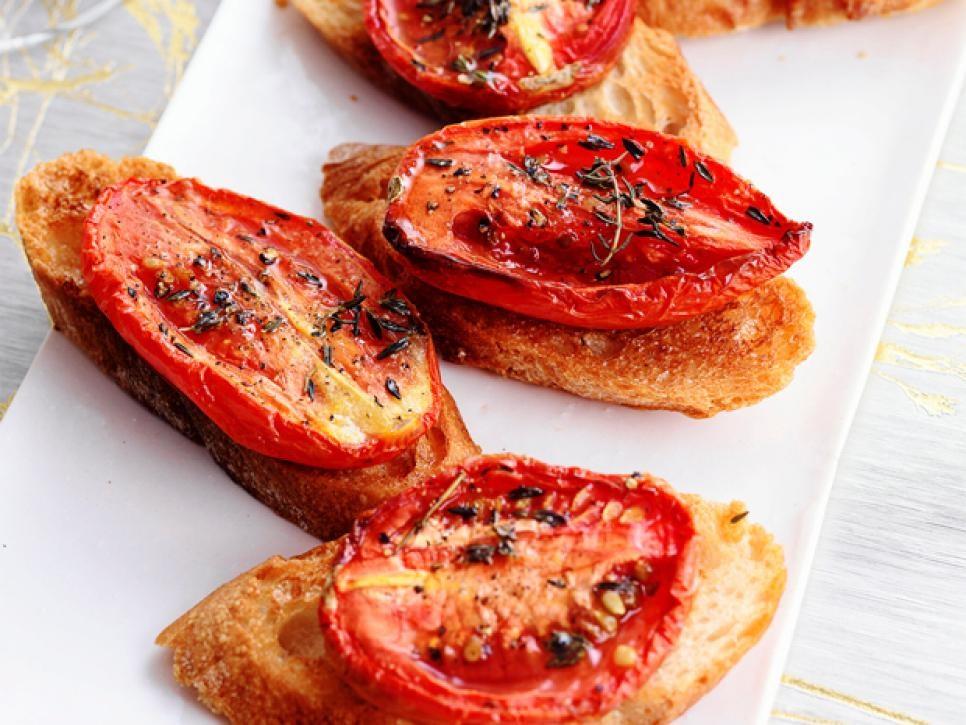Crostini with Thyme Roasted Tomatoes 4 plum tomatoes, halved lengthwise Extra virgin olive oil 1 to 2 teaspoons dried thyme 8 1/2 inch thick slices baguette 1 clove garlic 1.