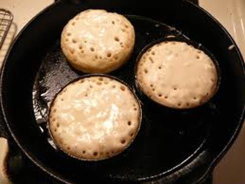 5. Place one ring in the heated pan, add enough batter to fill just below the top of the ring. Cook for five minutes when there should be many tiny holes on the surface and the crumpet is setting.