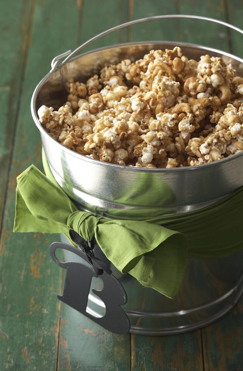 caramel corn 14 cups popped popcorn 2 cups whole almonds and/or roasted, salted cashews (optional) 1 cups packed brown sugar 3/4 cup butter 1/3 cup light-color corn syrup teaspoon baking soda