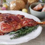 Rosemary-Roasted Leg of Lamb Yield: serves 6-8 1 7- to 9-pound leg of lamb, bone in 1 large bunch of rosemary 5 cloves of garlic, peeled 2 tablespoons salt 1 tablespoon black pepper 1 cup red wine 1.
