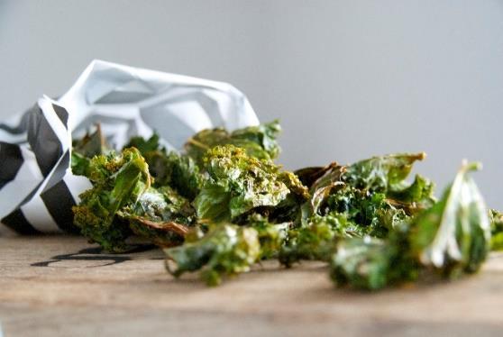 Cheesy Kale Chips [Serves 2] 2 heads of kale torn into large pieces 4 teaspoons extra virgin olive oil 2 tablespoon nutritional yeast sea salt and