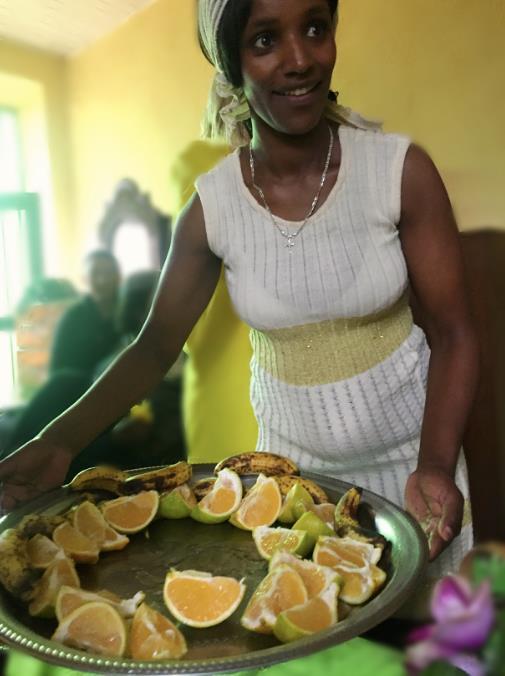 A woman serving fruits as a snack