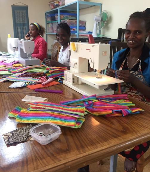 Women sewing reusable pads at the WRAPS foundation