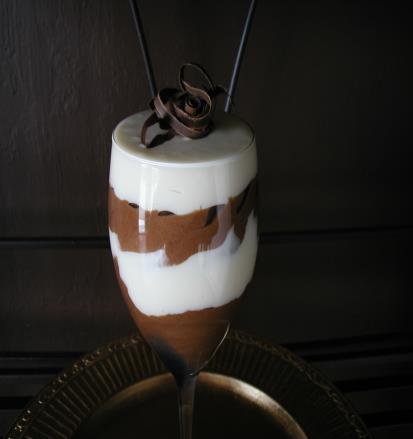 with mascarpone, dusted with cocoa powder and served with chocolate shavings LAYERED CHOCOLATE