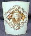 A Royal Doulton 3.8 inch by 3.5 inch beaker with a rim that is gilded, with brown china. Manufactured at Nile England. 'Bone, A.J., Mr.' is associated with this item. Referenced in: 1327x.
