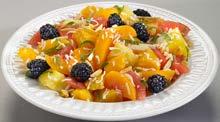 Ambrosia Salad Tart fruit salad topped with blackberries, coconut, mint, and