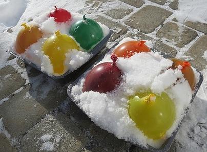 off the water balloons, place into stockings and hang. (Can also use food coloring).
