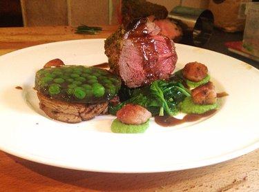 To plate up place the fried pressed disc of lamb on the plate and top with the mint and pea