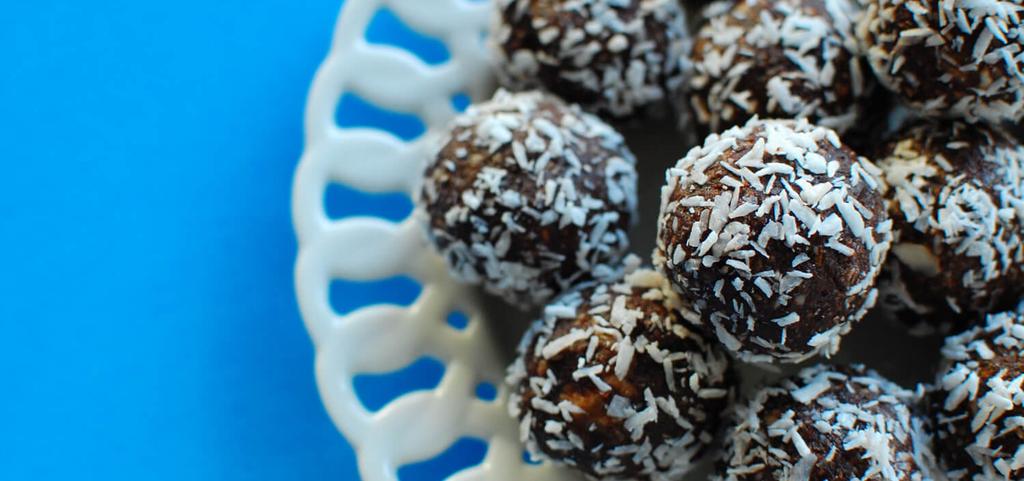 15 MINUTES Almonds Cocoa Powder Unsweetened Coconut Flakes (divided) Pitted Dates (soaked and drained) Coconut Oil Raw Honey Combine the almonds, cocoa powder, and half of the shredded coconut