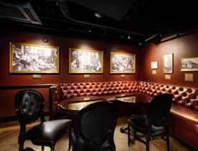 The speakeasy exhibit is built around a well-stocked bar and space