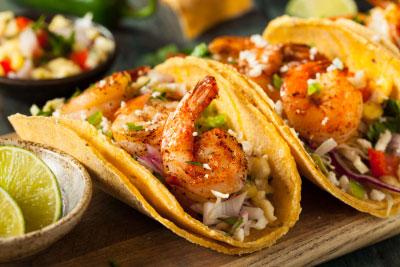Cheats Mexican Brunch Serves: 4 1 tbsp Olive Oil 1 Lime, juice only 2 Garlic Cloves, crushed ½ Red Chilli, finely chopped 400g King Prawns, peeled 8 Taco Shells* 1 Romaine Lettuce, shredded 200g