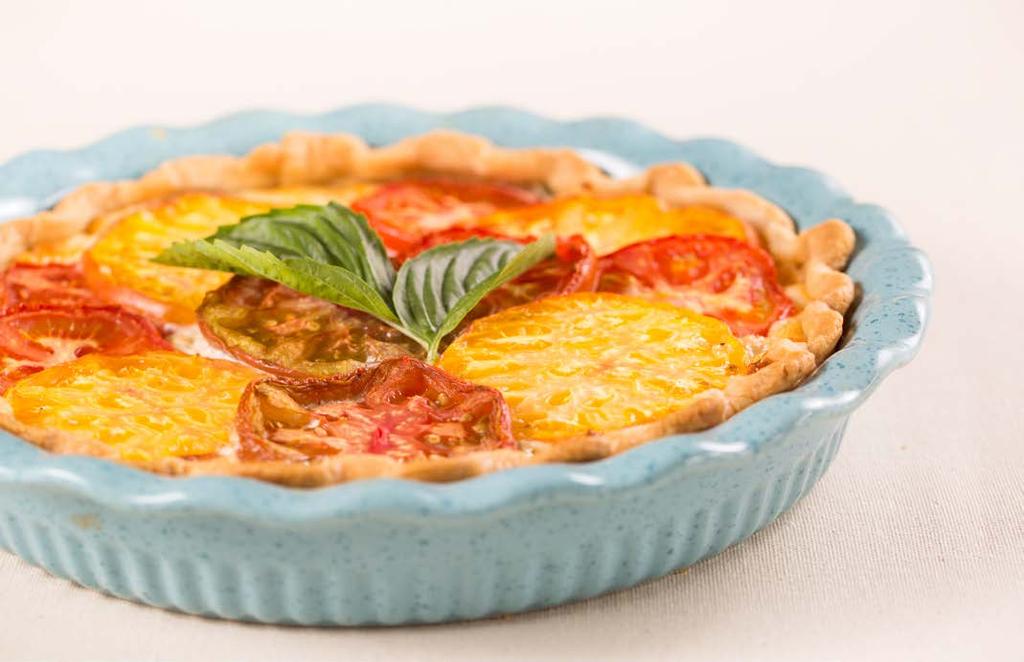 Tomato Pie 4 tomatoes, peeled and sliced ¼ cup fresh basil leaves, cut into strips ½ cup chopped green onion 1 pre-baked pie crust (9 inch) 1 cup grated mozzarella 1 cup grated cheddar ¼ cup shredded