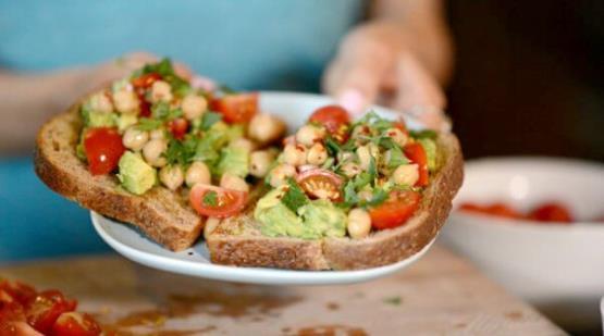 Avocado Toast with Garbanzo Beans Makes 1 serving Prep time 10 min 1 large avocados 1/2 cup cherry tomatoes 1/4 cup garbanzo beans 1/2 lemon 1 Tbsp. olive oil 1 Tbsp. parsley 1 tsp.