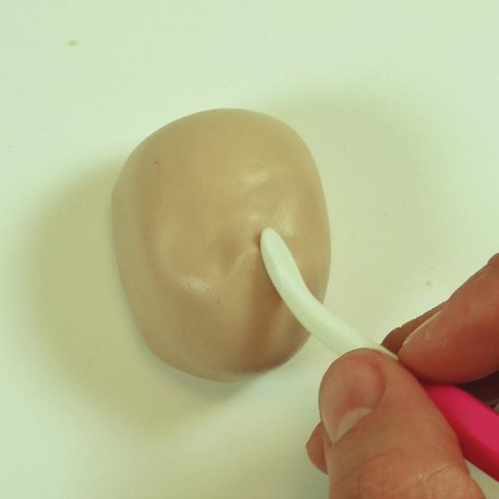 Draw the mouth using a tool with a silicon tip,