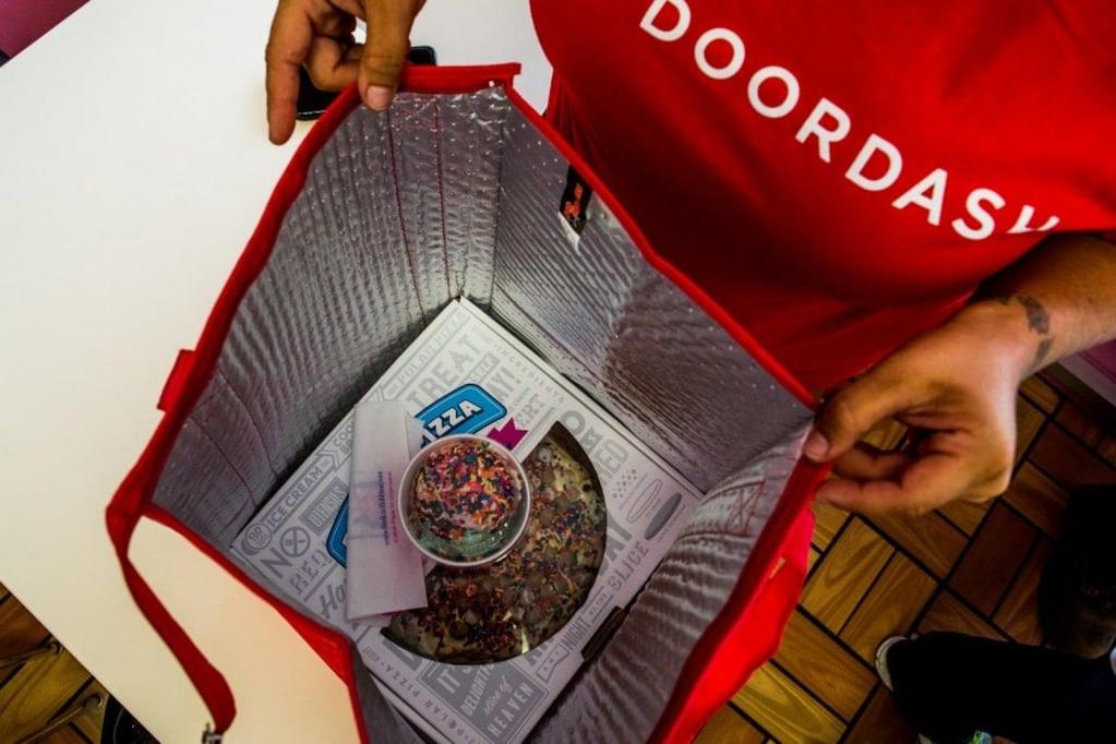 A DoorDash driver starts to bag up an order in Daly City, Calif.