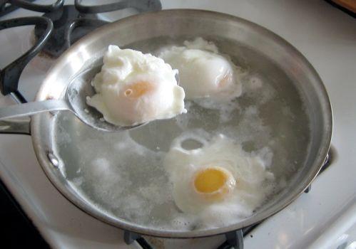 Poach cook (an egg), without its