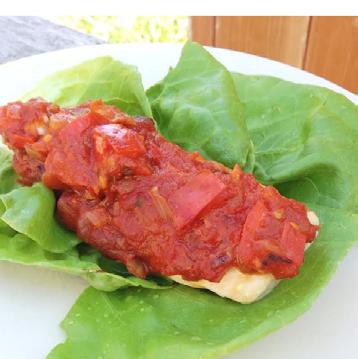 Spicy Italian Chicken [Makes 4 Servings] 1 onion (diced) 1 red pepper (diced) 1 tablespoon coconut oil 1 teaspoon cayenne pepper 2 cups Basic Tomato Sauce 2 chicken breasts 4+ big lettuce leaves (or