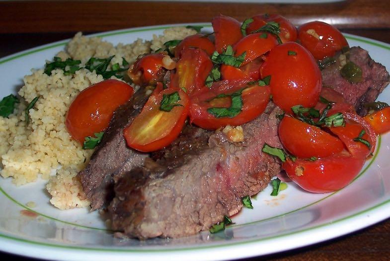 Steak with Tomato Topping Preheat broiler. Combine 1 teaspoon cumin, 1/2 teaspoon salt, and red pepper; sprinkle evenly over steak.