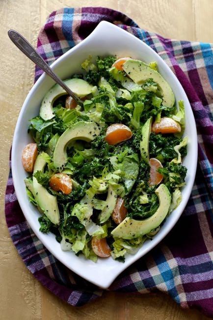 Kale and Avocado Salad Place kale in a large bowl and drizzle with olive oil and a pinch of salt. Massage the oil and salt into the kale. Add the romaine, tangerines, and avocado the the bowl.