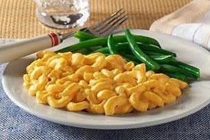 Creamy Mac-and-Cheese Serves 12 : 8 tablespoons (1 stick) unsalted butter, plus more for casserole 6 slices white bread, crusts removed, torn into 1/4- to l/2-inch pieces 5 1/2 cups milk 1/2 cup