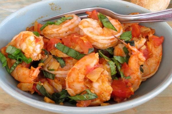 Shrimp with Fennel and Tomatoes Serves four 2 TBS unsalted butter 1 TBS olive oil 1/2 cup chopped onion 1 medium fennel bulb chopped 4 garlic cloves minced 4 large tomatoes peeled and