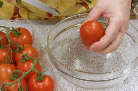 4 While the onions are cooking, prepare the tomatoes for peeling by