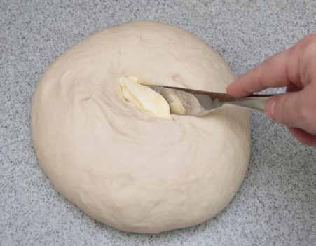 10 Cut a slit into the dough, push a small scoop of butter (1 or 2 tablespoons)