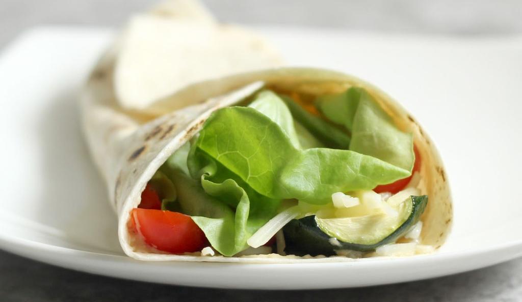 ENTREES Zucchini Hummus Wraps 1 large zucchini, ends removed and thinly sliced 1 tbsp olive oil ½ tsp ground sea salt 2 tortillas ¼ cup hummus ½ cup halved cherry tomatoes 2 large bibb lettuce leaves