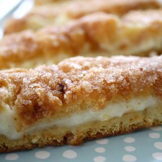 Sopapilla Cheesecake 1. 2 cans Pillsbury butter crescent rolls 2. 2 ( 8oz) packages cream cheese ( softened) 3. 1 cup sugar 4. 1 tsp vanilla 5. 1/4 cup butter ( melted) 6. 1 tbs cinnamon 7.