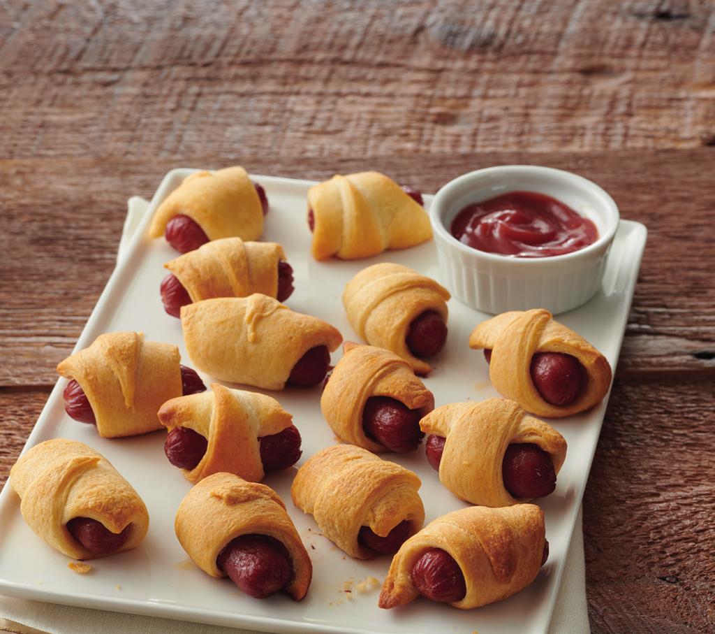 Pigs IN A BLANKET 12 15 minutes 15 minutes 2 (8 oz.) SE Grocers refrigerated crescent rolls 2 (14 oz.) cocktail-size smoked sausage or hot dogs 1. Heat oven to 375ºF. 2. Unroll both cans of dough and separate into 16 triangles.