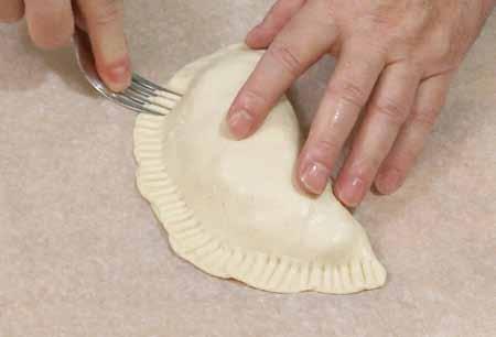 10 7 You can stitch the seam together with the tines of a fork. If you prefer a cleaner look, you can trim the edge with a fluted pastry cutter.