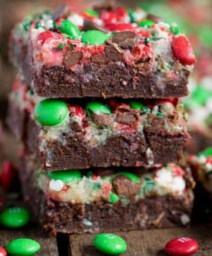 Christmas Magic Layer Brownie Bars Submitted By: Valerie Washington Brownie Layer: 1 ½ cups semi-sweet chocolate chips ½ cup (1 stick) salted butter 1 cup granulated sugar 2 large eggs + 1 yolk 1 cup
