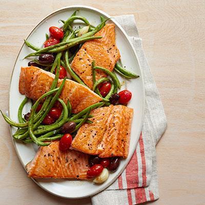 Roasted Salmon, Green Beans and Tomatoes 6 clove garlic 1 lb. green beans 1 pt. grape tomatoes 1 cup pitted Kalamata olives 3 anchovy fillets 2 tbsp. olive oil Pepper 1 skinless salmon fillet 1.