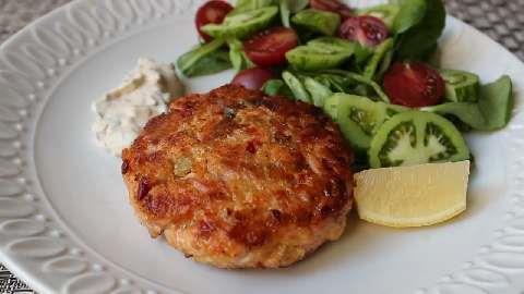 Salmon Patties 2 (15oz) cans pink salmon 1 onion (finely diced) 1 egg (beaten) 8 saltine crackers (crushed) Salt and pepper to taste 1 stalk celery 1 cup cornmeal 1/8 cup olive oil 1.