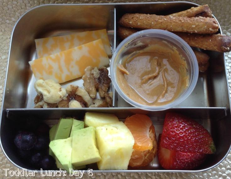 In this lunch he had some cheese, walnuts, whole grain pretzels and peanut butter to dip, and a rainbow of fruit including blueberries, avocado, pineapple, mandarin oranges, and strawberries.