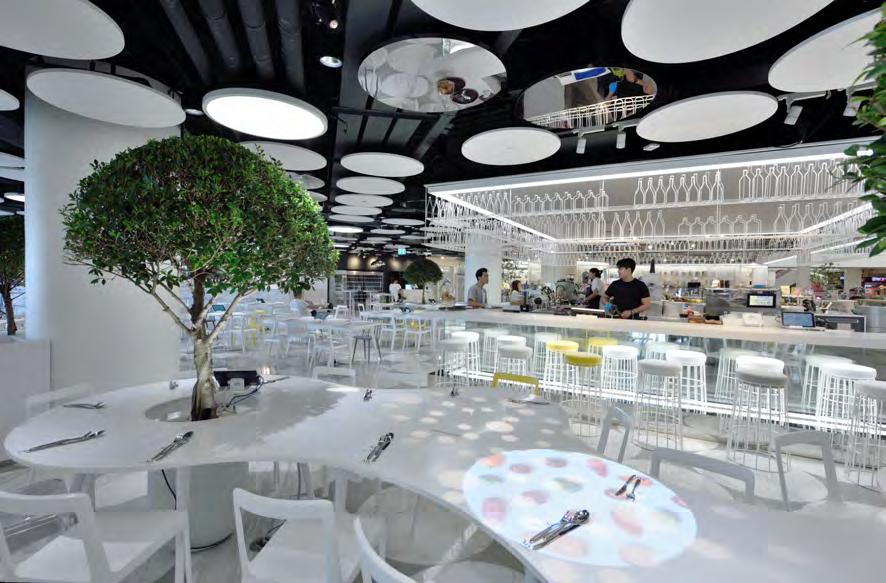 white Volakas marble, circular white ceiling tiles, chairs and