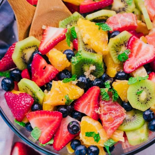 Fruit Salad 1 pint strawberries sliced 5 kiwis sliced 5 oranges peeled and diced 2 grapefruit peeled and diced 12 ounces blueberries 1 cup Mint chopped and divided 1/2 cup Orange juice (or juice from