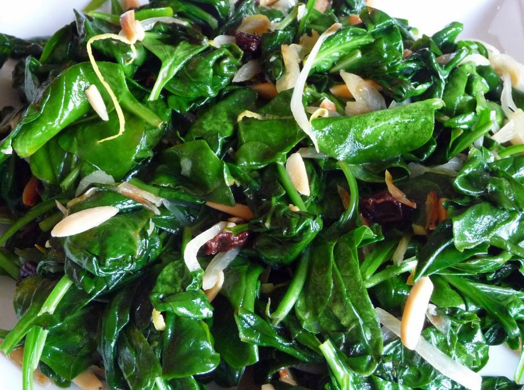 SAUTEED SPINACH w/ Almond Slivers 1/4 cup extra-virgin olive oil 2 cups sliced almonds 2 garlic cloves, minced 1 small shallot, chopped 2 10-ounce packages of spinach, raw salt and pepper to taste